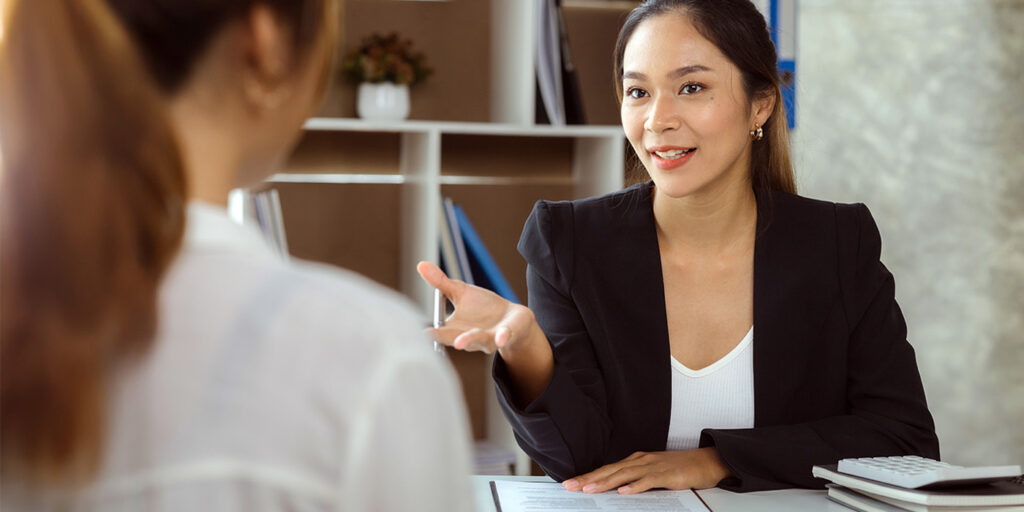 A businesswoman engaging in a professional discussion with a colleague.
